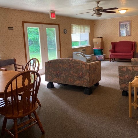 a living room with couches and a table and chairs